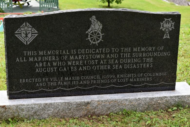 A tombstone is etched with a dedication to mariners of Marystown and others lost to storms.