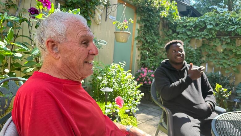 Host and student sitting in the backyard. 