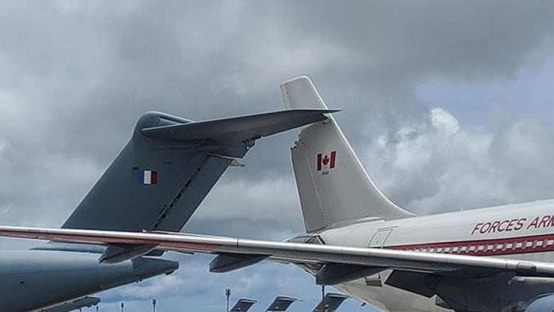 The wing of a Canadian CC150 Polaris, right, is damaged after backing into aFrench plane, left, also damaged while on a tarmac in Guam in July. 