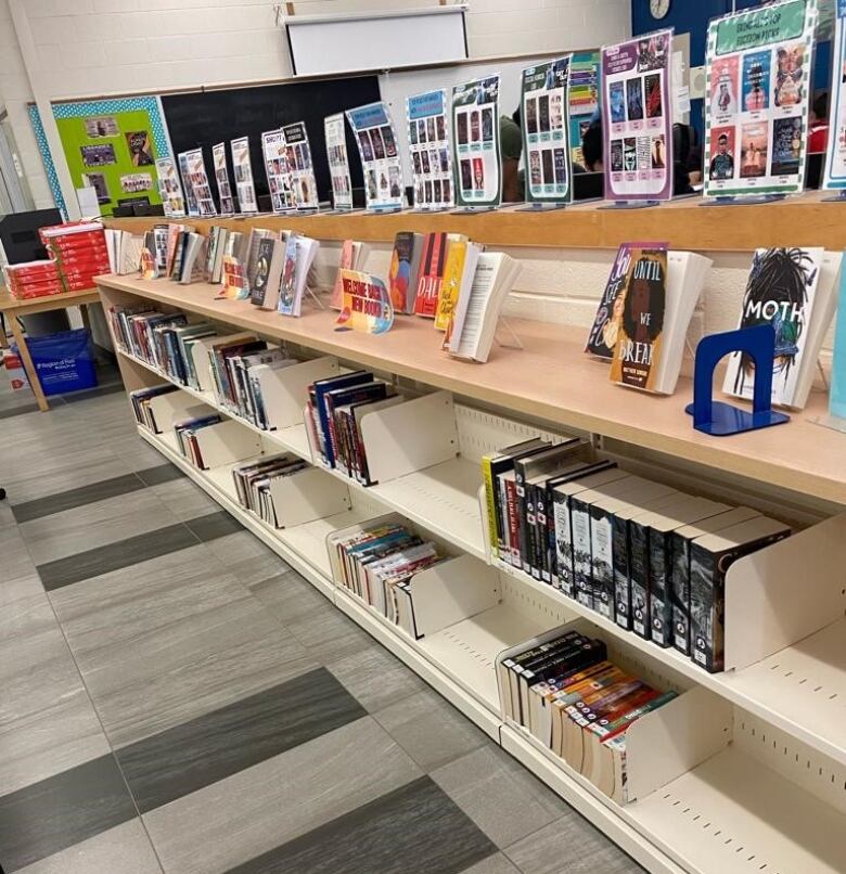 Bookshelves with partially filled shelves in a school library.