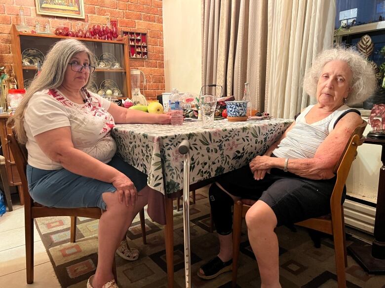 A photograph of Bernadette Mamo and her 86-year-old mother mother at the dining table. The photo was taken during last week's heat wave in Toronto. 