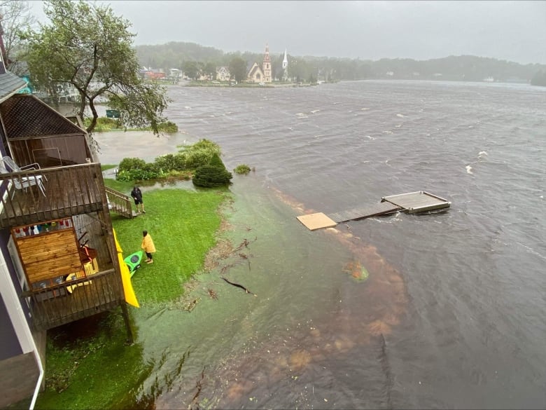 A jetty is shown partially submerged next to a home.