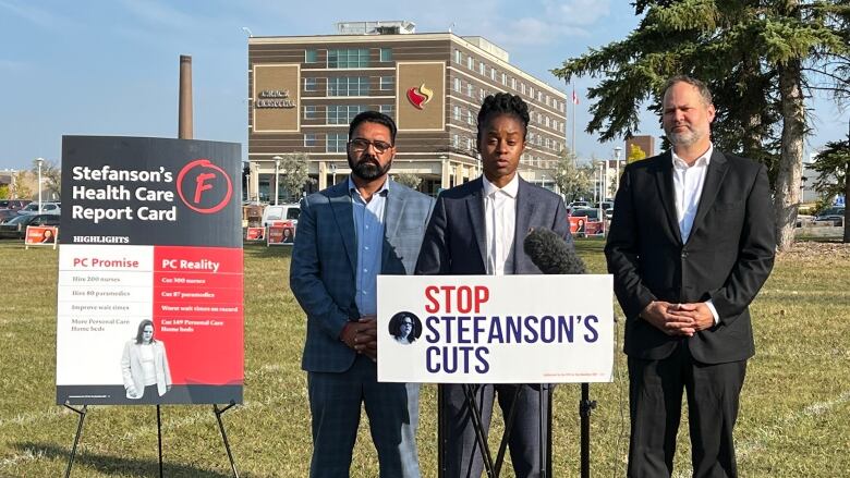 People standing with placards in a park.