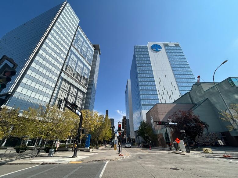 Downtown high rise buildings at a busy street corner on a sunny day.