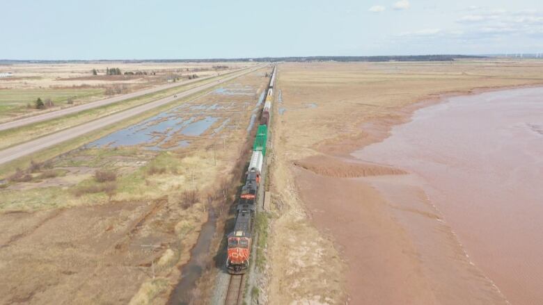 A train beside water. 