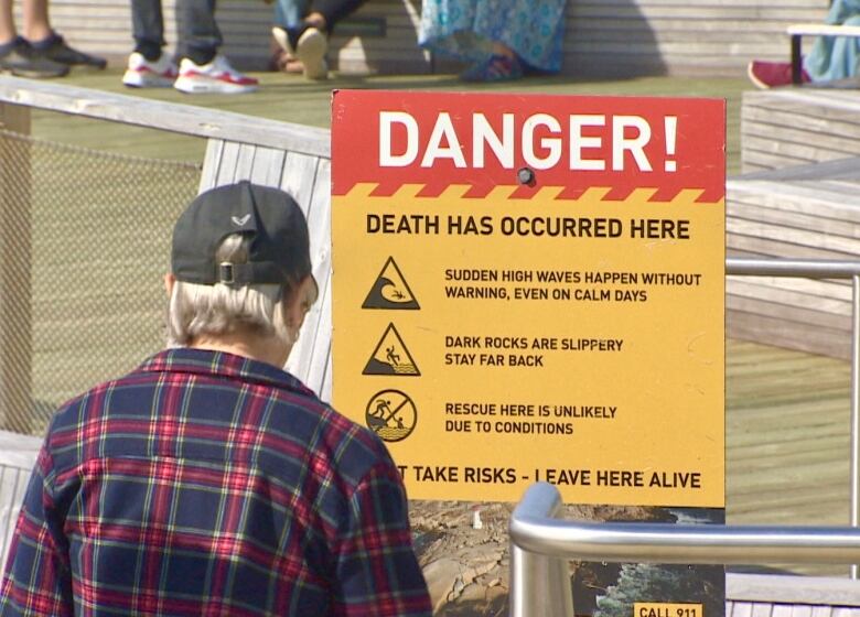 Several signs are posted at the Peggys Cove site to warn visitors of the dangers caused by crashing waves. 