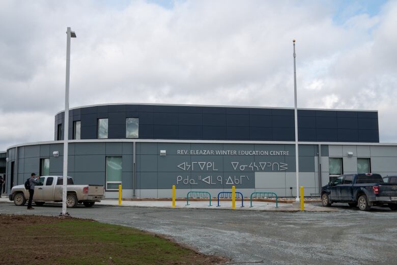 A wide shot of a grey building.