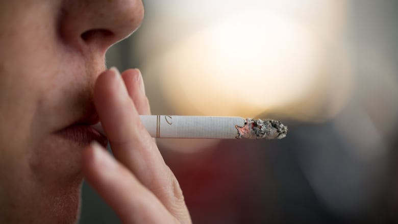 A woman smoking a cigarette.