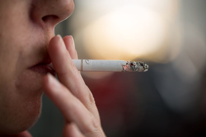 A woman smoking a cigarette.