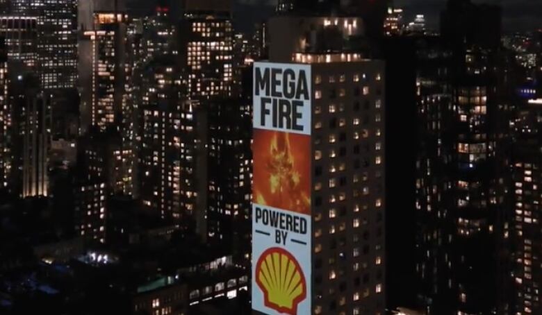 A billboard reading 'Megafire powered by [Shell logo]' is projected on the side of a building in a metropolis at night.