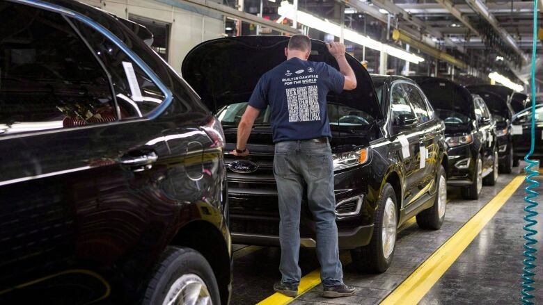 Vehicles sit on a production line at a Ford plant in Oakville, Ontario. 