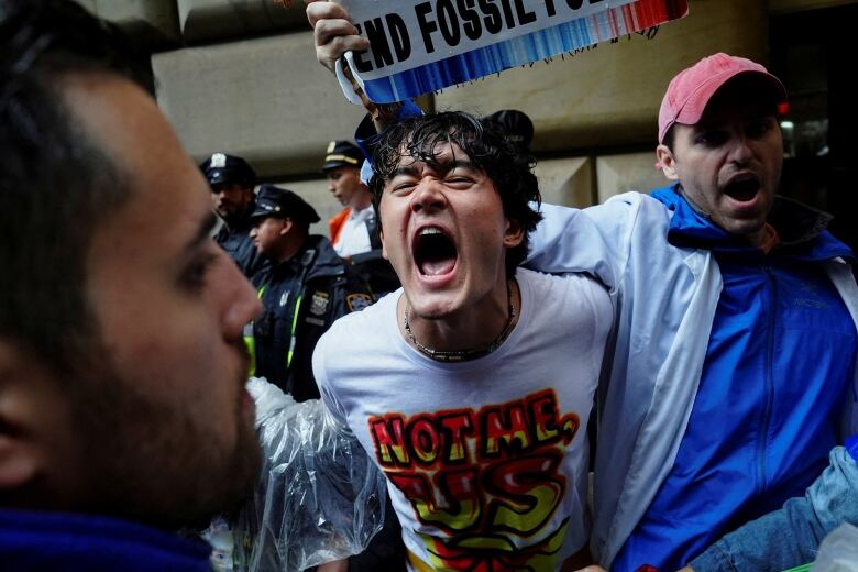 Climate activists tussle with police.