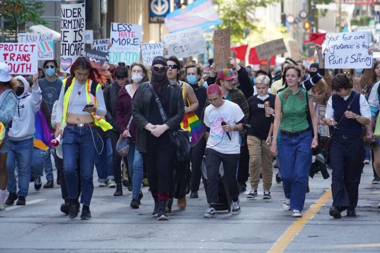 Protesters walk in the street.