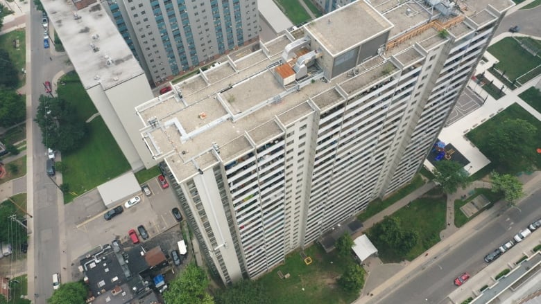 A high rise is seen from the sky looking down it.