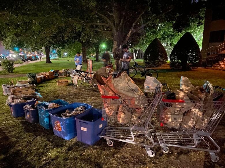 Boxes of food are set up on the lawn of a church.