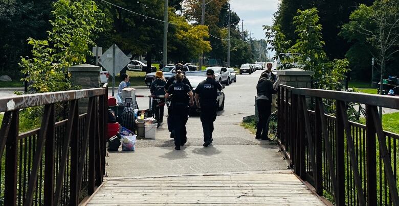 Some police officers near of the road of Cambridge's Soper Park. 