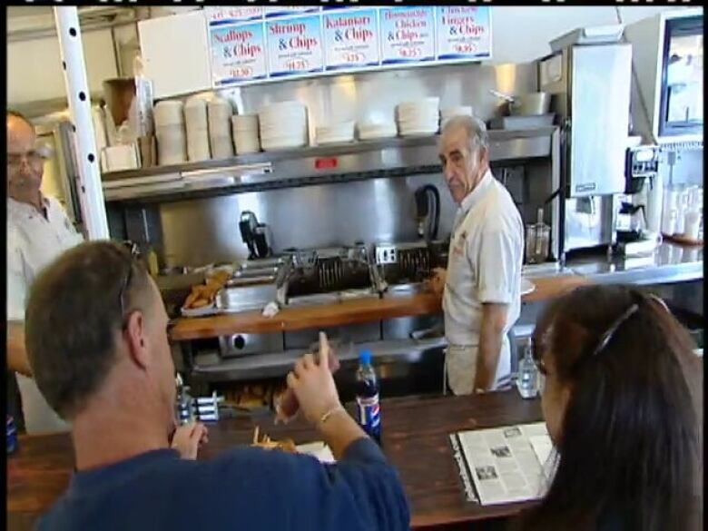 Fotis Fatouros serves customers at John's Lunch in this file photo from 2007.