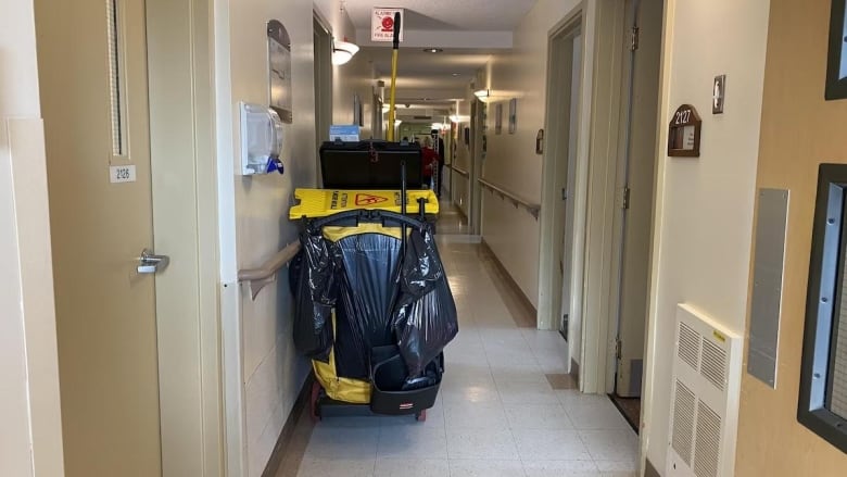 a very narrow hallway of a seniors' residence