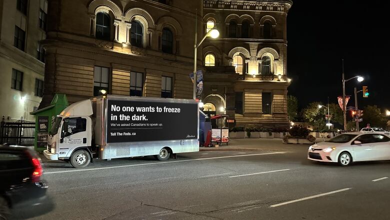 A truck is shown parked at night in from of the Parliament Buildings in Ottawa.