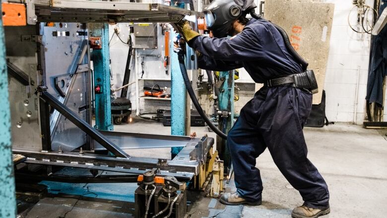 A worker welds at a Volkswagen owned facility in Quebec.