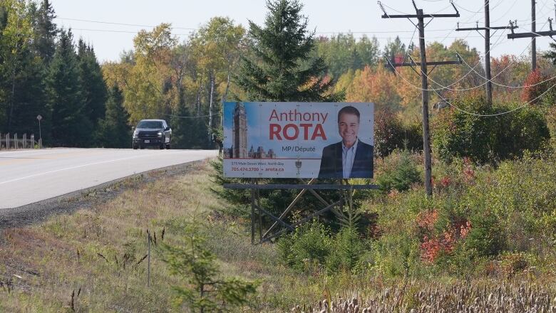 A sign on the side of the road says 