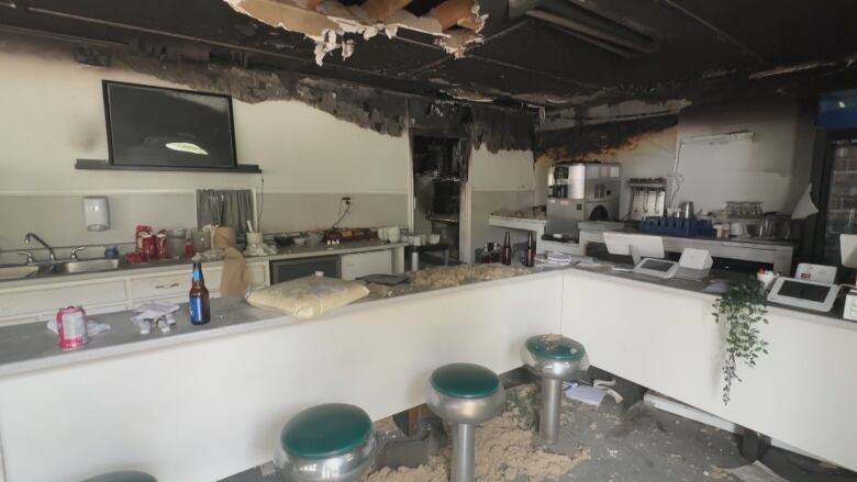 A picture of the damage in the dining area of the restaurant shows walls and the ceiling are burned. 