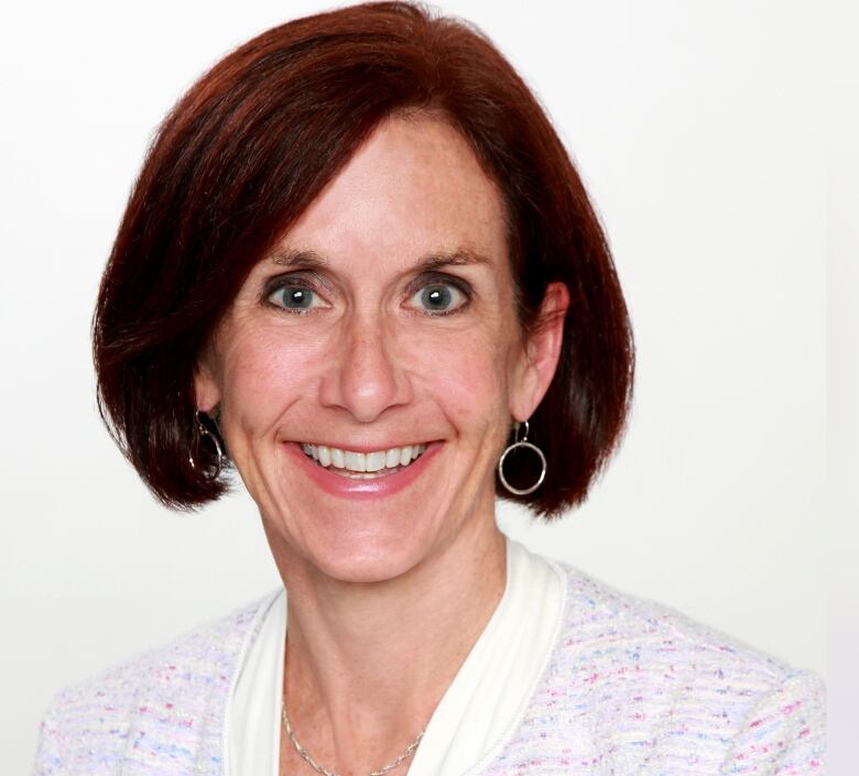 A smiling woman with dark hair and a short bob hairstyle.