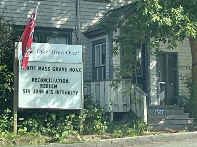 Sign in Murray Harbour that reads Truth: Mass Grave Hoax. Reconciliation: Redeem Sir John As Integrity.