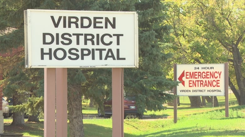 Two signs are shown in trees. One says Virden District Hospital, the other says 24 hours emergency entrance.