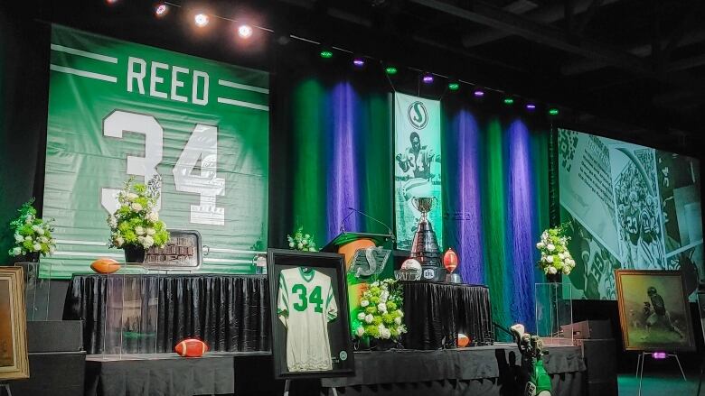 A shrine to George Reed fills a stage, inside a hall at a trade centre.