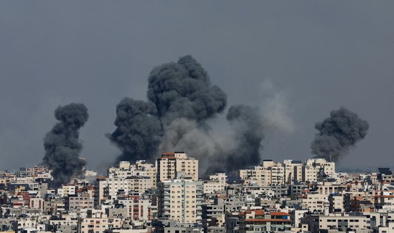 Black smoke rises from apartment buildings.