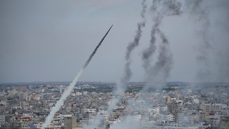 Rockets are launched by Palestinian militants from the Gaza Strip towards Israel, in Gaza, Saturday, Oct. 7, 2023. The militant Hamas rulers of the Gaza Strip carried out an unprecedented, multi-front attack on Israel at daybreak Saturday, firing thousands of rockets as dozens of Hamas fighters infiltrated the heavily fortified border in several locations by air, land, and sea and catching the country off-guard on a major holiday. (AP Photo/Hatem Moussa)