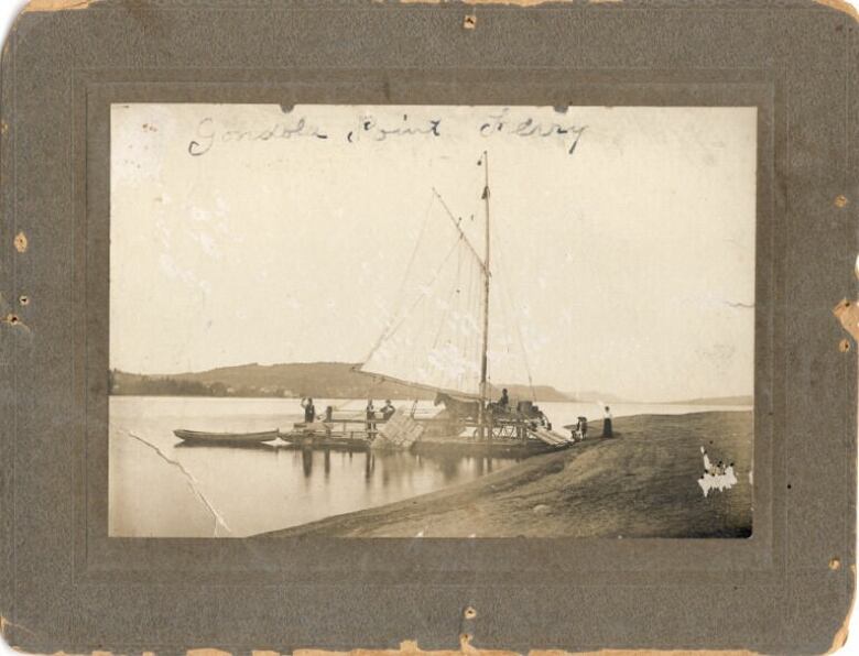 A black-and-white photo of a hose and wagon boarding a sail and oars ferry. 