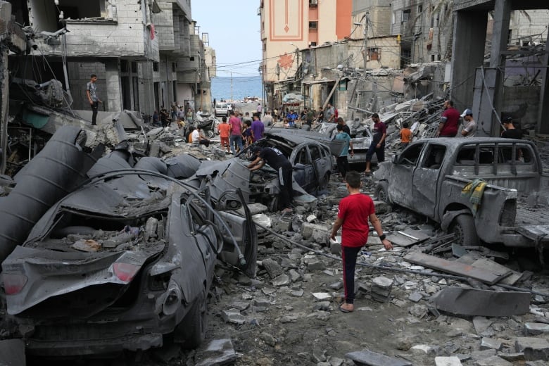 People inspect the rubble of a mosque destroyed after it was hit by an airstrike.