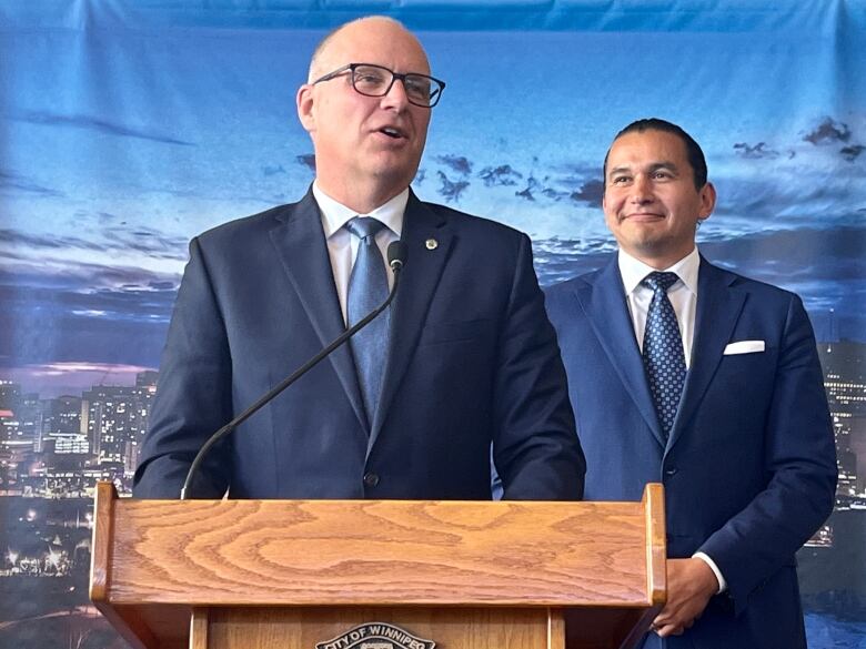 Two men standing at a podium.