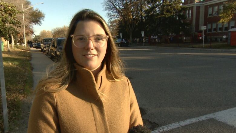 Cathlia Ward is standing in front of Monique-Rousseau school