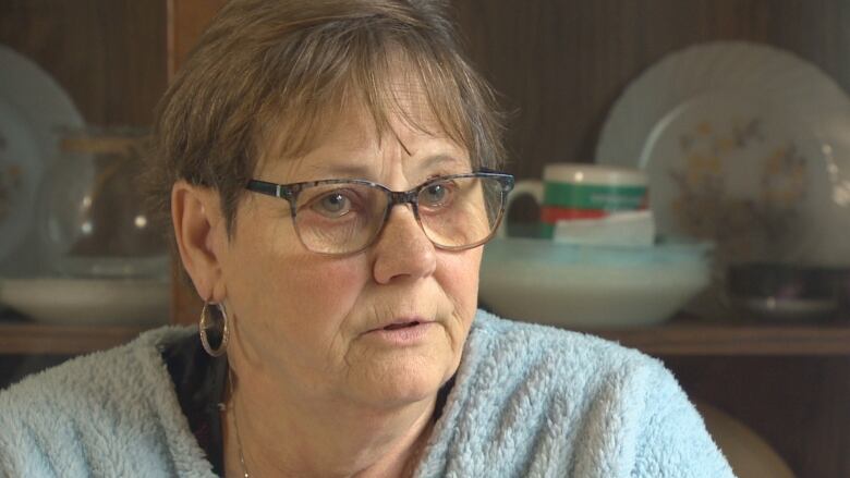 Wanda Poster sits in the living room of her home near Fredericton.