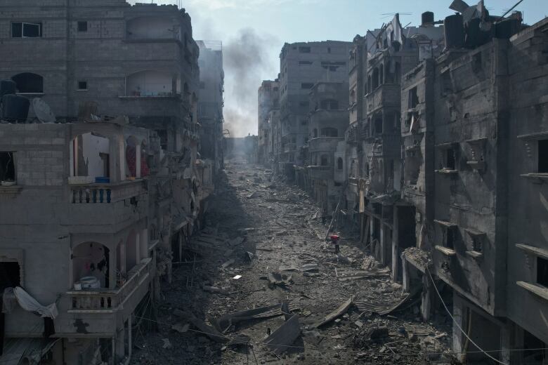 Rubble litters a street between smoldering buildings hit by an Israeli airstrike in Jabaliya, Gaza Strip, Wednesday, Oct. 11, 2023.