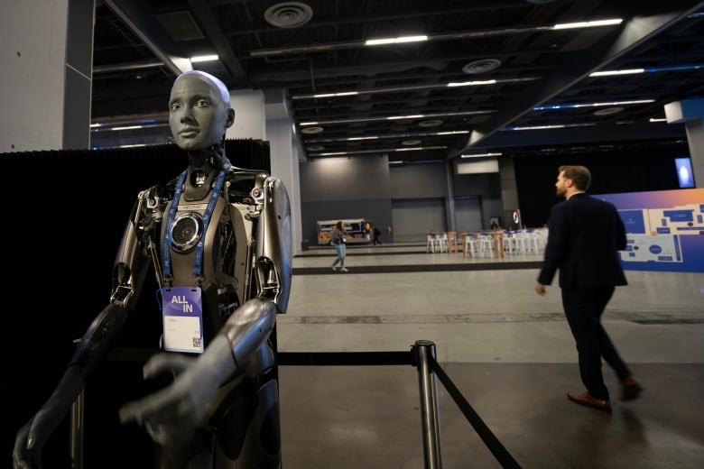 A robot from Ivado Lab looks at the camera during the All-In conference in Montreal.