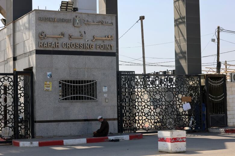 A Palestinian man kneels to pray at the Rafah gate, leading from Gaza to Egypt.