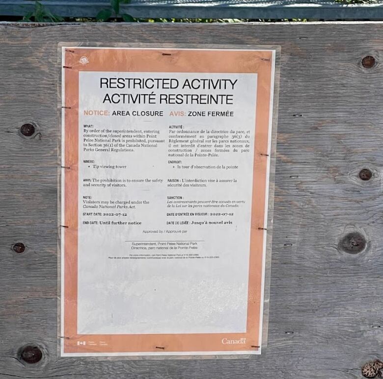 A sign at the bottom of the Point Pelee observation tower indication the structure is closed for safety reasons.