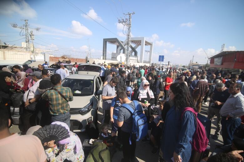 Palestinians wait to cross to the Egyptian side at Rafah border, Gaza Strip