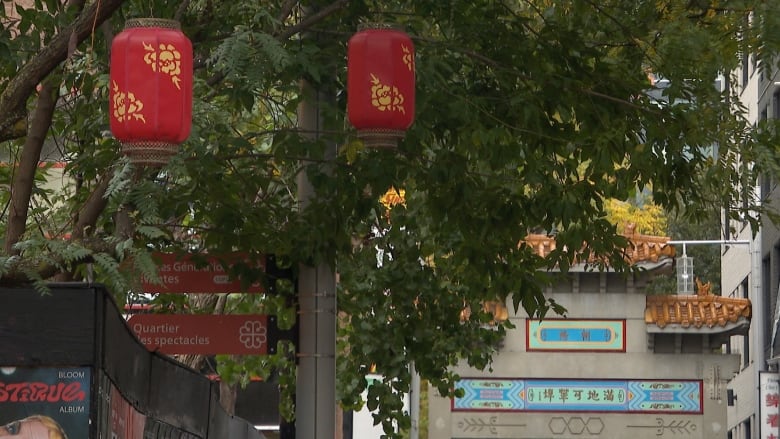 Red lanterns and chinatown rooftops among some trees