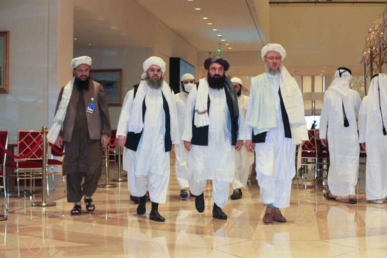 The Taliban delegation arrives for Afghan peace talks in Doha, Qatar, Thursday, Aug.12, 2021.