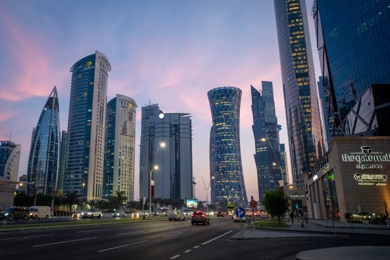 Skyscrapers in a city at dusk.