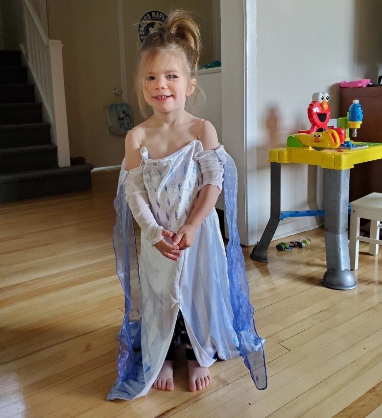 A toddler in a dress-up costume.