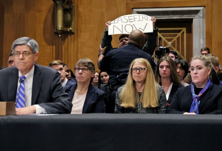 Protester holds sign 