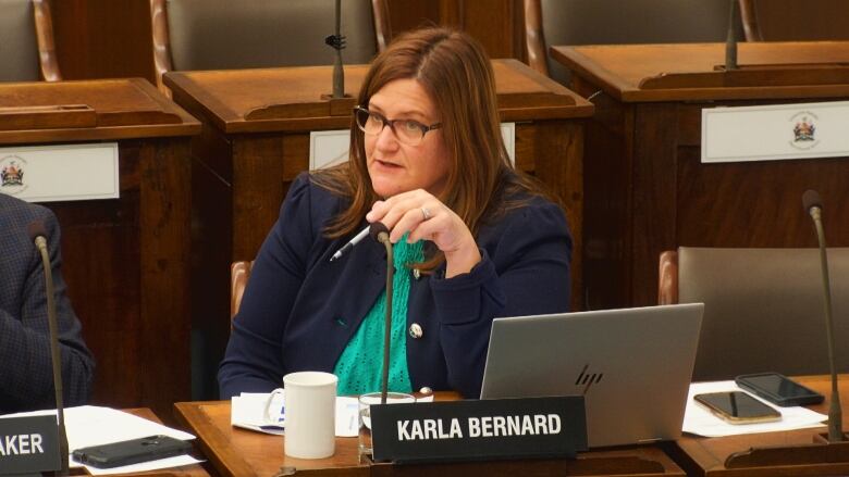 Karla Bernard at desk.