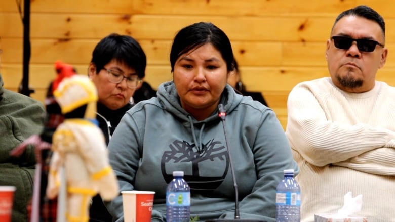 A woman speaks in an official proceeding.