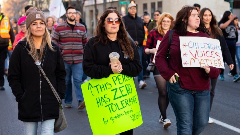 People carry signs for take back the night.